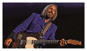 Tom Petty jouant sur scène avec une guitare Fender Telecaster.